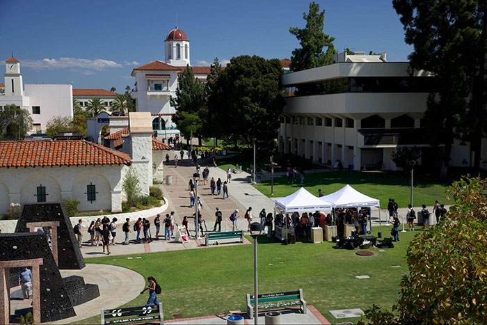 Wide view of Google Gemini tents and event booths on SDSU’s campus, with students gathered around and lining up.