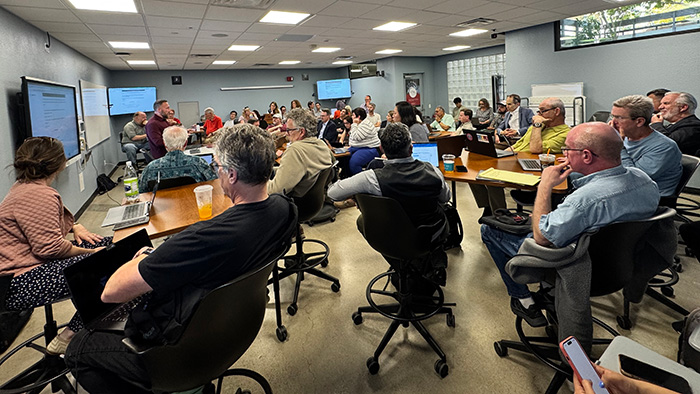 Large group of faculty and staff seated in a classroom, engaged in a presentation and discussion during SDSU OpenAI Day 2025.