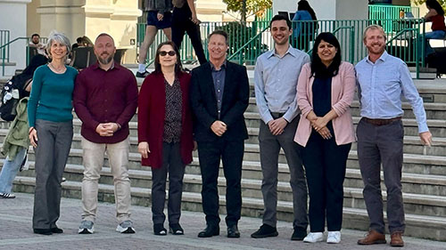 Group photo of SDSU OpenAI Day organizers and presenters standing together outdoors, celebrating a successful day of AI-focused sessions and workshops.